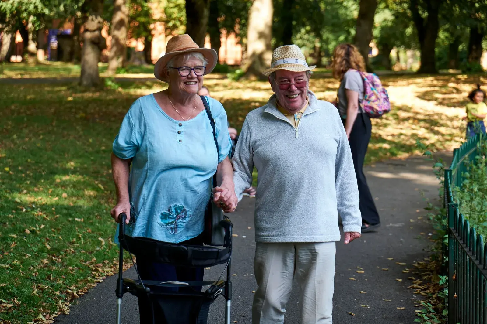 A couple enjoying a sunny walk in a park